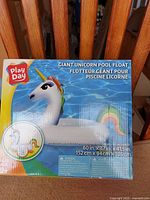 Front of retail box displaying Play Day giant unicorn pool float