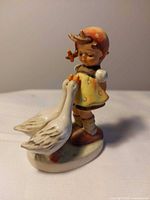 Front view of Hummel Goose Girl figurine showing girl and geese