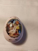 Front view showing Goose Girl scene and gold accents