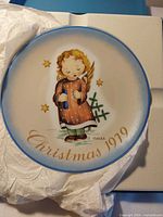 Front view of plate showing angel illustration and inscription