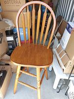 Full view of oak swivel bar stool