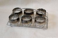 front angled view of six tumblers in metal caddy