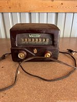 Front view showing dial, brand name, knobs, and power cord