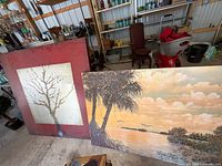 Both canvas prints leaning against shelving