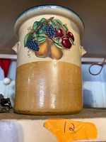 Front view showing fruit motif and two-tone glaze