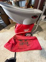 Full view of Lobster Elite Grand V machine with red bag