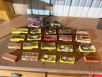 Table layout of boxed lures, bagged spoons and reel