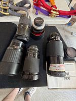 Five lenses, caps, manual on black mat