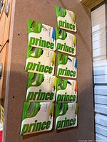 Nine Prince polyester string packs displayed on board