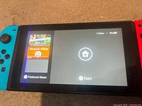 Nintendo Switch powered on showing home screen with Joy-Con attached