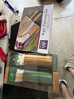 Front view of Raymour & Flanigan 4-pc carving set box and two Starbucks tumblers in packaging