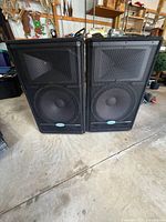Front view of both Samson RS15HD speakers showing grilles and woofer/horn layout