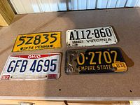 Four license plates laid out showing overall condition