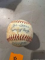 Overall view of signed baseball showing one autograph panel