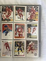 Nine hockey cards in binder sleeve, showing brands Upper Deck, Score, Pro Set, Fleer, players Joe Nieuwendyk, Adam Oates