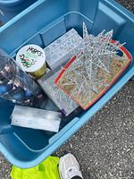 Contents of blue tote showing star, hooks container, boxed decor
