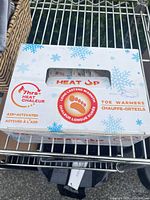 Front of Heat Up toe warmers box showing branding and window with pouches