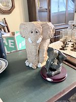 Both elephant figurines grouped together showing overall form and condition