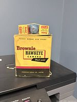 Front of Kodak Brownie Hawkeye retail box with flash bulb and two VP620 film boxes visible