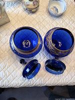 Pair of cobalt blue compotes shown open with lids off, interior and rim details visible