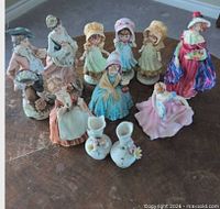 Group shot of all ten porcelain and ceramic figurines on table