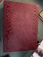 Closed burgundy wood-grain flatware storage chest