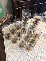 Full set of smoky gray goblets with amber stems arranged on table
