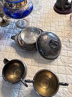 All components of silver-plated set showing gilt interiors and tarnish