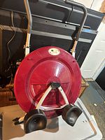 Full view of Ab Circle Pro machine showing red disc, knee pads, handlebar
