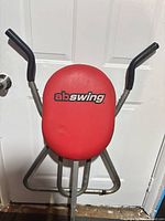 Front view showing red seat with ab swing logo and handlebars