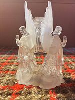 front view showing two praying angels and central candle socket