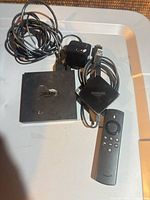 Overall lot: two Fire TV units, remote, adapter, cables