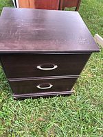 Front view showing two drawers, dark finish, silver pulls