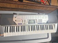 Top view of Casio CTK-496 keyboard showing keys, control panel, and speakers