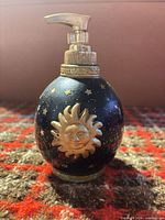 Front view showing gold sun motif and pump