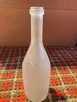 Full view of frosted glass bottle displaying overall shape and size