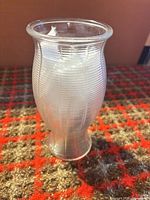 Vase front profile displaying ribbed texture and flared rim