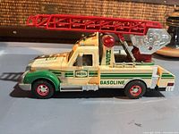 Left side view of Hess rescue truck showing graphics, ladder, light bar
