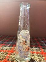 Front view showing vase shape and cherub decal