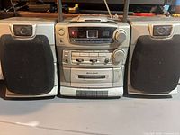 Front view showing central unit and both detachable speakers