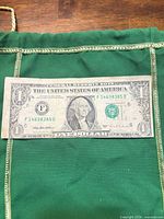 Front view of 1995 $1 bill showing off-center print