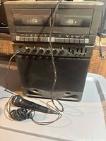 Front view of Optimus dual cassette karaoke center with attached microphone cable
