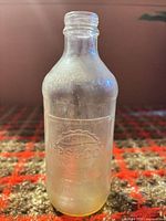 Full view of clear embossed Pepsi bottle showing overall form and texture