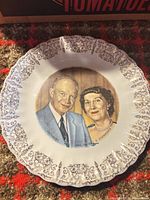 Full view of porcelain plate with portrait and gold filigree rim