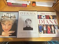 Front covers of three books: People The Diana Years, Diana Princess of Wales A Tribute in Photographs, and Dressing Diana