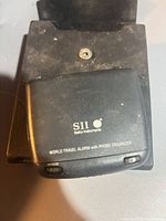 Closed Seiko Instruments DF4022 device on its attached stand showing branding and snooze button