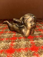 Left front view of bronze-tone sleeping cherub figurine