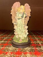 Front view of Three Hands Corp resin angel figurine on base