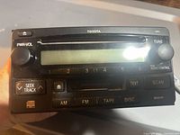 Front view of Toyota OEM head unit showing controls and slots