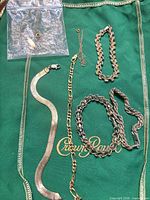 All seven bracelets laid out on green cloth for overview